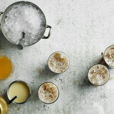 an overhead view of cocktails on a table with ice and lemonade in glasses