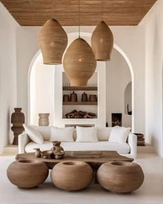 a living room filled with white furniture and lots of wooden decorations on the ceiling above