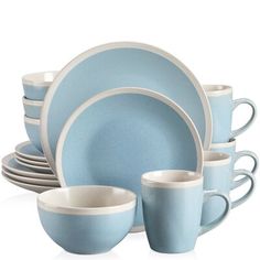 a blue and white dinner set with cups