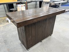 a large wooden table sitting inside of a garage