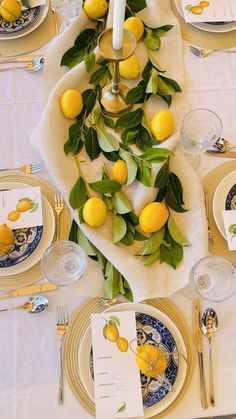 the table is set with lemons and place settings