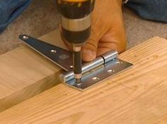 a person using a drill to fix a piece of wood