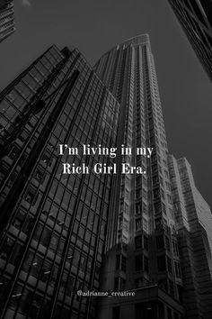 the words i'm living in my rich girl era are shown above tall buildings