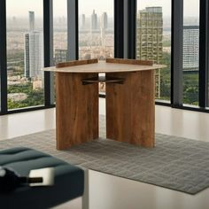 a room with large windows and a table in the middle on carpeted flooring