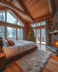 a bedroom decorated for christmas with a tree in the corner and a fire place next to it