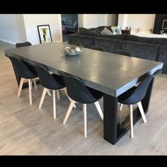 a large table with chairs around it in a living room