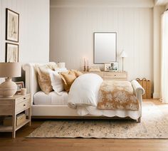 a bedroom with white walls and wooden floors