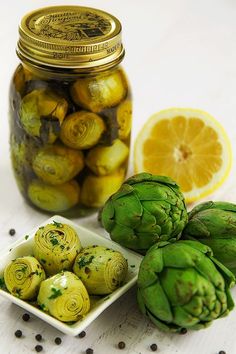 artichokes and lemon are sitting on a table