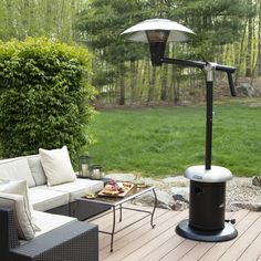 an outdoor living area with furniture and an umbrella over the fire pit on the deck