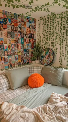 an unmade bed with lots of pictures on the wall and pillows in front of it