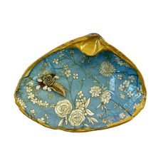 a blue and gold plate with flowers on it