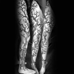 two legs with tree tattoos on them