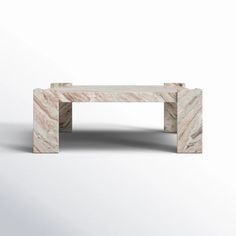 a marble coffee table sitting on top of a white floor