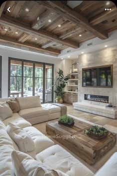 a living room filled with furniture and a flat screen tv mounted to the wall next to a fire place