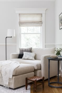 a living room filled with furniture and a window