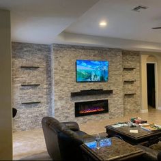 a living room with two couches and a flat screen tv mounted on the wall