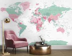 a living room with a pink chair and a large map on the wall behind it