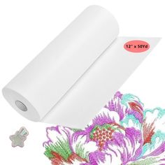 a roll of white paper next to a flower with an image of flowers on it