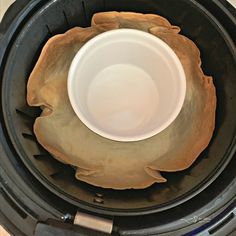 a white bowl sitting inside of an open air fryer