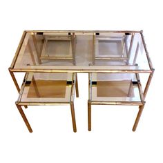 This is a beautiful and rare Set of a Coffee Table and Nesting Sides Tables in Hollywood Regency style, in a beautiful condition, from the 1970's, in gilt metal faux bamboo by the renown Maison LANCEL The tables have the glass mirrored bands insert into the frame.  Very elegant set for distinguish interiors. Small tables sizes: W: 15 in D: 15 in H: 15 in  Also available : A pair of two tiers sides table or consols or pedestal, togather they can composed a unique five pieces set. Brass Coffee Table, Hollywood Regency Style, Long Table, Elegant Sets, Table Sizes, Metal Mirror, European Vintage, Faux Bamboo, Coffee Table Setting