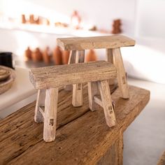 two wooden stools sitting on top of a table