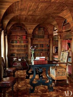 an old library with many bookshelves and chairs