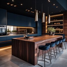 a modern kitchen with blue cabinets and bar stools in the center, along with an island