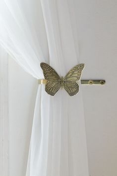 a curtain with a butterfly attached to it