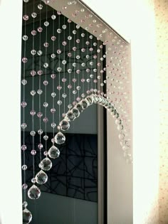 a mirror with beads hanging from it's side