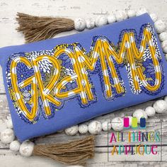 a blue bag with the word creme on it and tassels around it