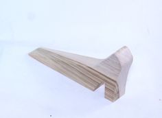 a wooden object on a white surface that looks like it is made out of wood