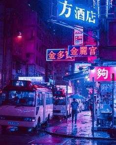 a city street at night with cars and people walking on the sidewalk in the rain