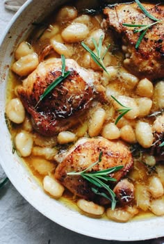 some meat and beans in a white bowl