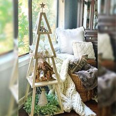 a wooden christmas tree sitting in front of a window