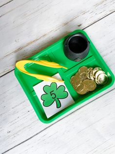 a st patrick's day craft tray with coins and scissors