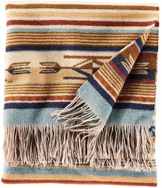 a multicolored blanket with fringes on it