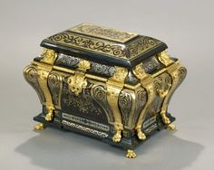 a gold and black box with ornate designs