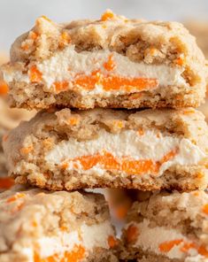 several cookies with orange and white frosting stacked on top of each other