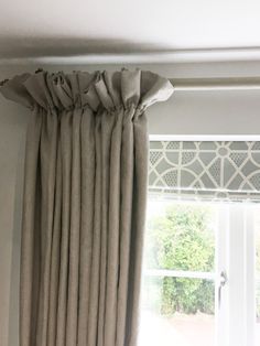 the curtains are hanging in front of the window