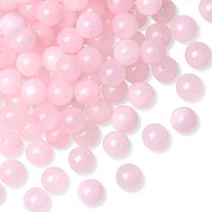 pink beads are scattered on top of each other in a pile, against a white background