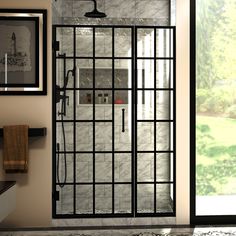 a bathroom with a glass shower door and tiled walls