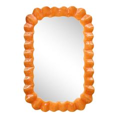 an orange mirror with wavy edges on a white background, it looks like the frame is made out of plastic