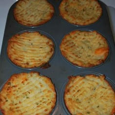 several baked food items in a pan on a stove top, ready to be cooked