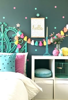 a bedroom decorated in pastel colors and polka dots