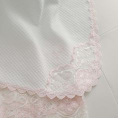 pink and white lace on the back of a dress