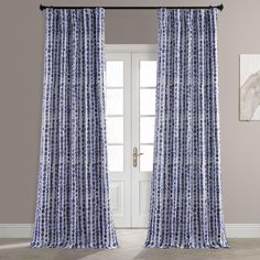 a blue and white curtain hanging in front of a door