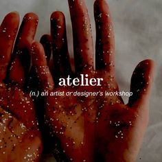 a person's hands covered in dirt with the words atelier above them and below it