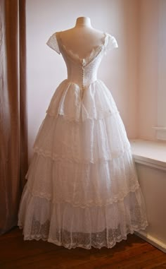 a white dress on display in front of a window