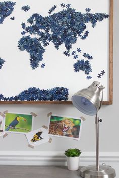 a wall with pictures and a lamp in front of it that is made out of puzzles