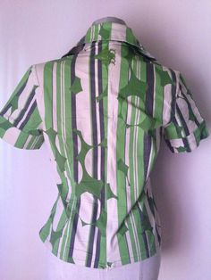 "Green Wrap Shirt, Japanese style 70s style with pointed collars Stunning patterned wrap blouse featuring green vertical stripes mixed with green circles and other abstract prints Wrap waist with button fastening Short sleeves, pointed collar, V-neckline, cotton fabric, low waist zipper Amazing combination of style! Asian bodice and collars with 70's references So cool abstract pattern, comfy fitting and absolutely trendy and hip looks! A unique 90's vintage piece, in great condition. ‼️Be aware Fitted Spring Tops With Geometric Pattern, Fitted Tops With Geometric Pattern For Spring, Fitted Geometric Pattern Tops For Spring, Green Retro Print Shirt For Spring, Green Vertical Stripes Button-up Shirt, Green Retro Print Short Sleeve Tops, Green Short Sleeve Tops With Retro Print, Green Vertical Striped Shirt For Summer, Green Geometric Pattern Tops For Summer